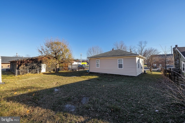 view of side of property with a lawn