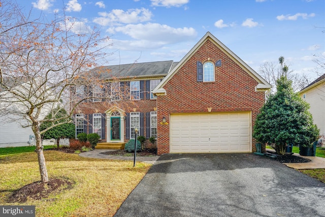 view of front of house featuring a garage and a front yard