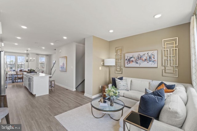 living room with sink and light hardwood / wood-style flooring