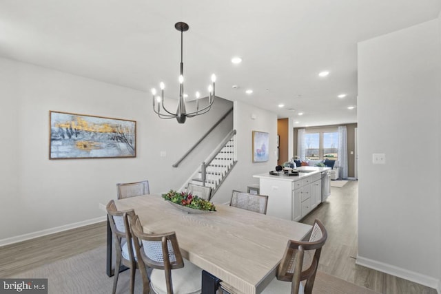 dining area featuring a notable chandelier and light hardwood / wood-style floors