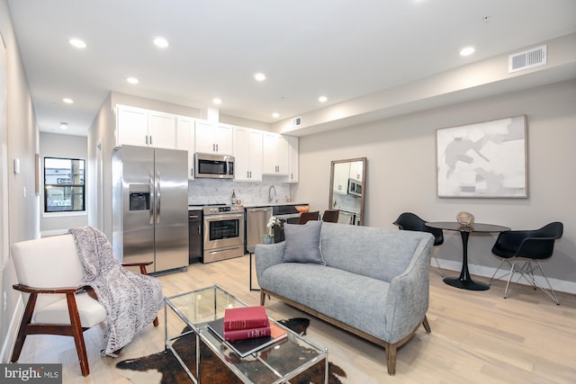 living room with light hardwood / wood-style floors