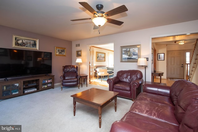 living room featuring ceiling fan and light colored carpet