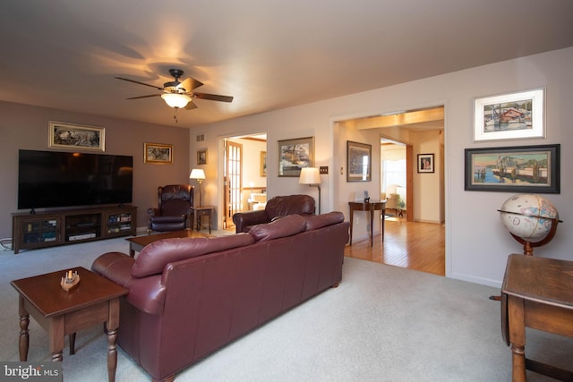 living room featuring ceiling fan and light hardwood / wood-style flooring