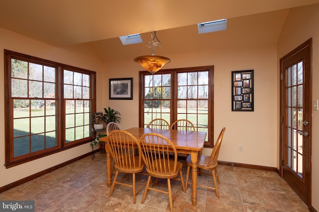 dining room featuring french doors and lofted ceiling with skylight