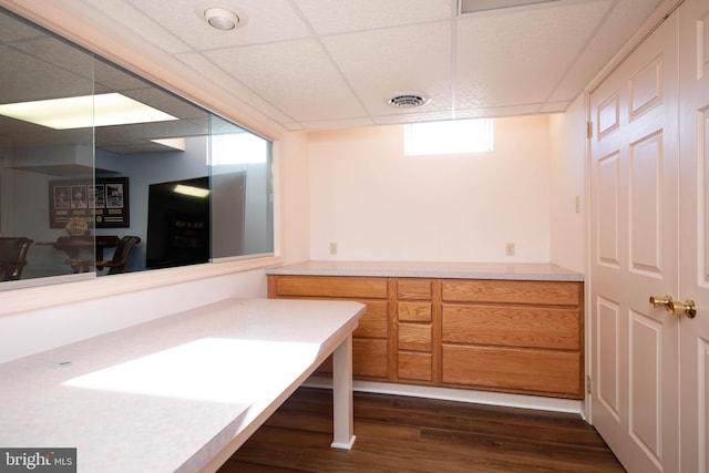 bathroom with hardwood / wood-style flooring and a drop ceiling