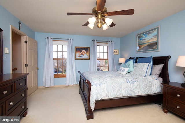 carpeted bedroom with ceiling fan