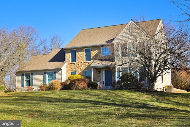 colonial-style house with central AC and a front lawn