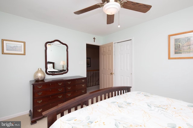 carpeted bedroom featuring a closet and ceiling fan