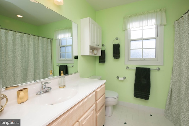 bathroom featuring tile patterned floors, vanity, and toilet