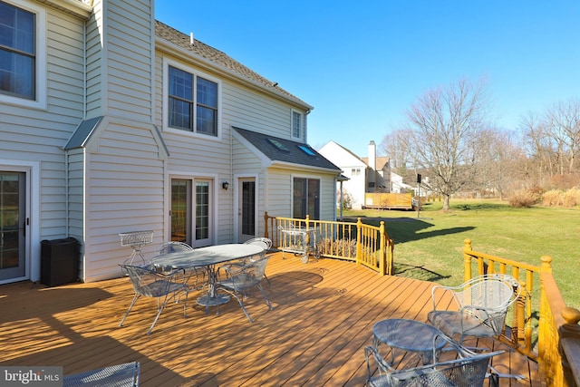 wooden terrace featuring a yard