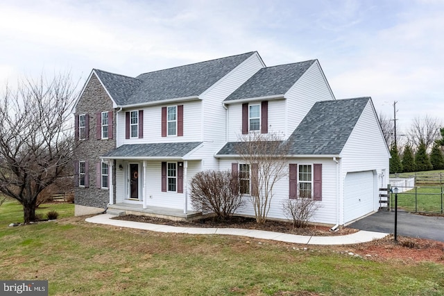 view of front of property featuring a front yard and a garage