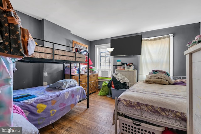 bedroom featuring hardwood / wood-style floors and cooling unit