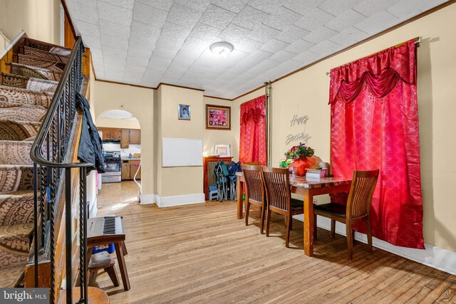 47 Liberty St, Trenton, NJ 08611 - dining room featuring arched walkways, wood finished floors, ornamental molding, and baseboards