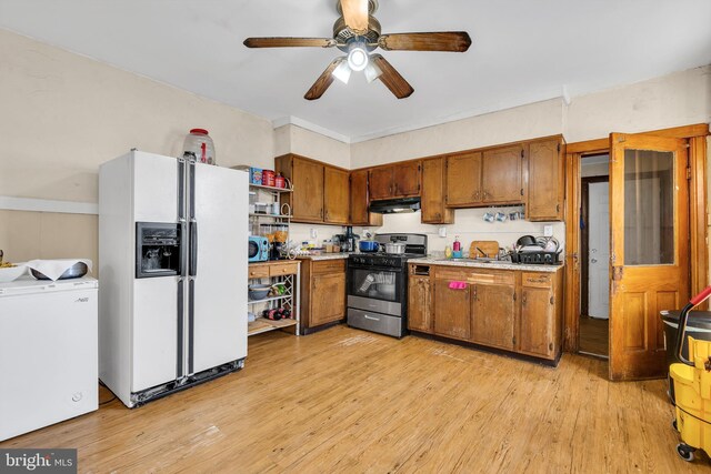 47 Liberty St, Trenton, NJ 08611 - kitchen with white refrigerator with ice dispenser, stainless steel range with gas stovetop, under cabinet range hood, open shelves, and brown cabinets