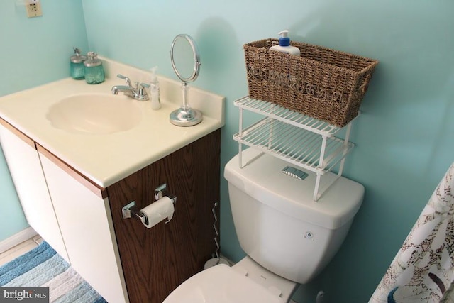 bathroom with tile patterned flooring, vanity, and toilet