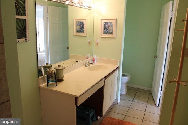 bathroom featuring tile patterned floors, vanity, and toilet