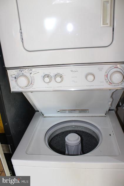 laundry room with stacked washer and dryer