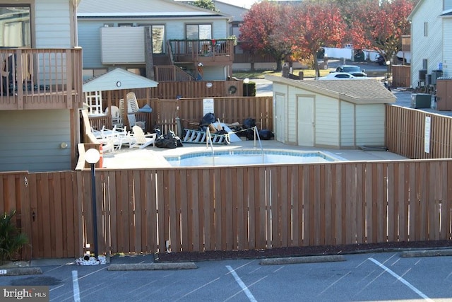 view of swimming pool featuring a shed