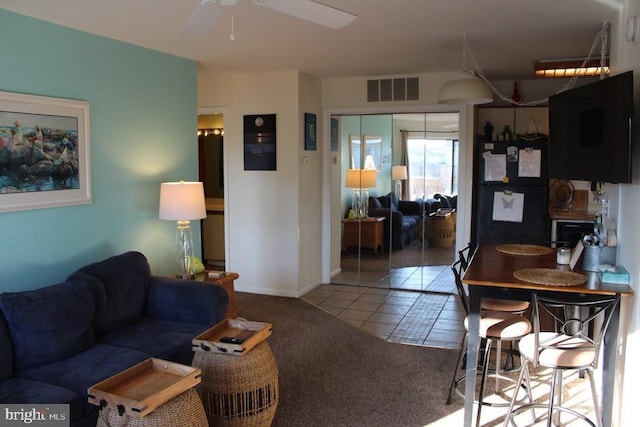 tiled living room featuring ceiling fan