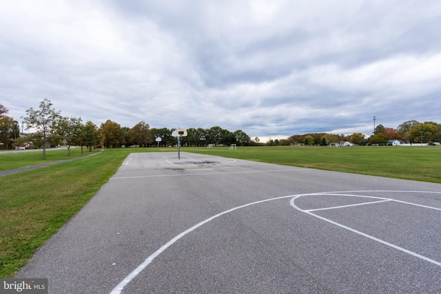 view of basketball court featuring a lawn