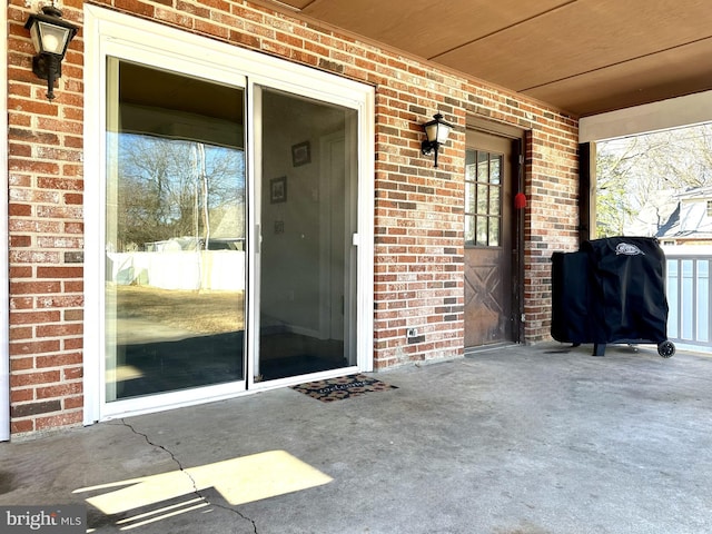 view of exterior entry featuring a patio