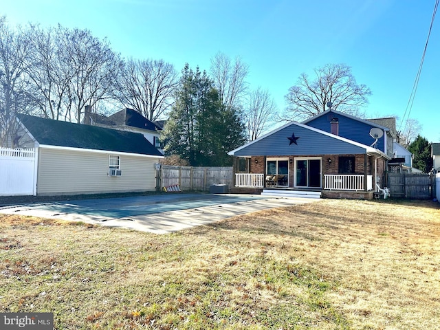 back of property with a patio area, a yard, and a porch