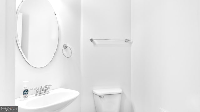 bathroom featuring sink and toilet