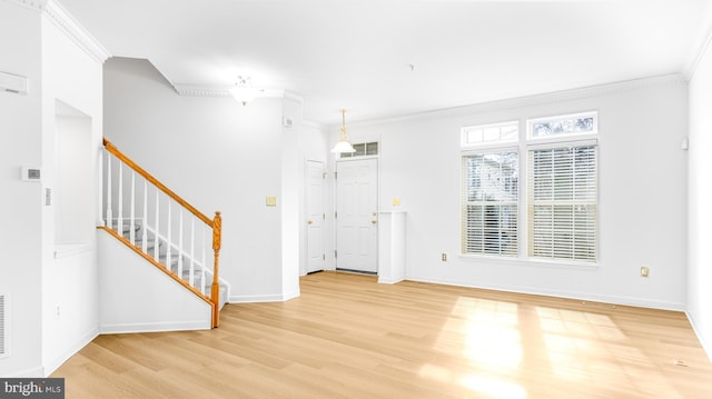 foyer with crown molding and hardwood / wood-style flooring