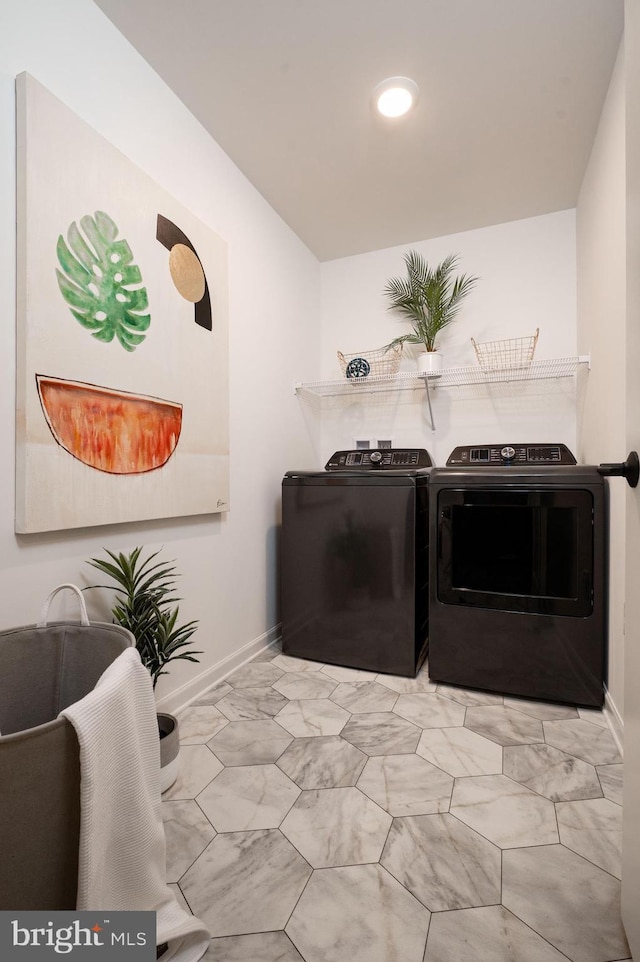 clothes washing area with washing machine and dryer