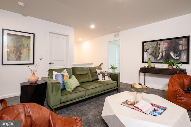 living room with dark colored carpet