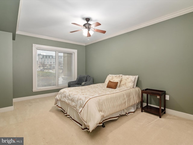 carpeted bedroom with ceiling fan and crown molding