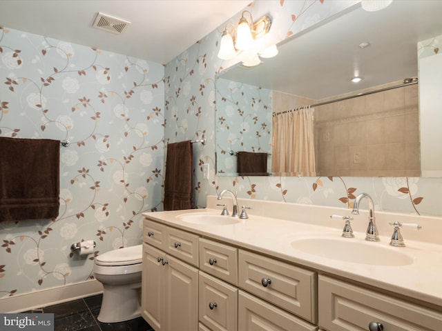 bathroom featuring curtained shower, vanity, and toilet