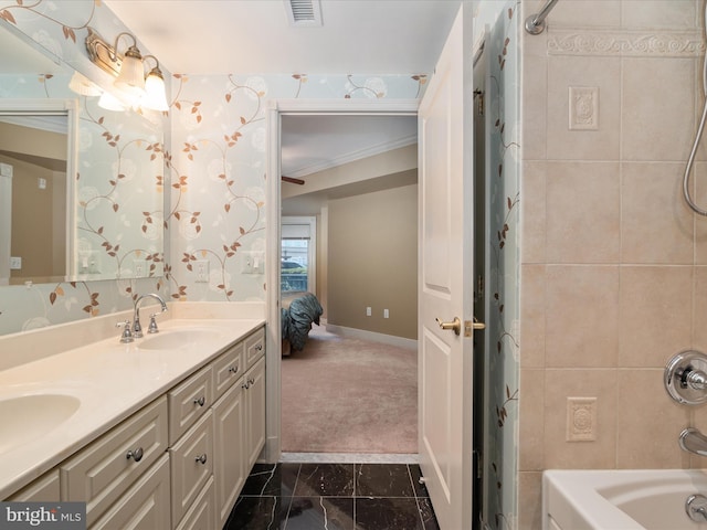 bathroom featuring crown molding, vanity, and tiled shower / bath