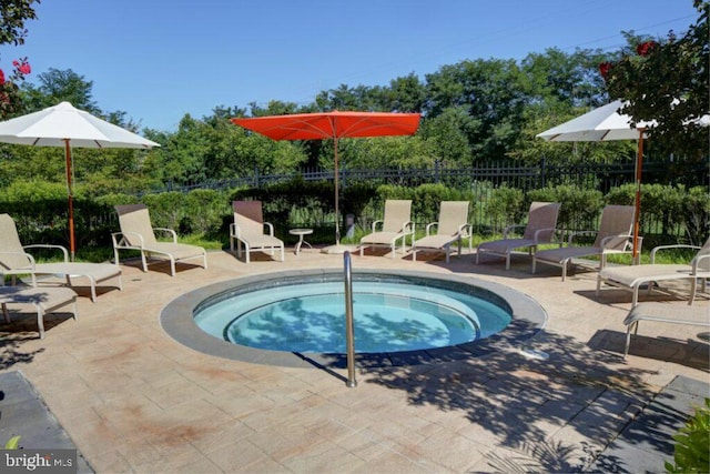 view of pool featuring a patio and a hot tub