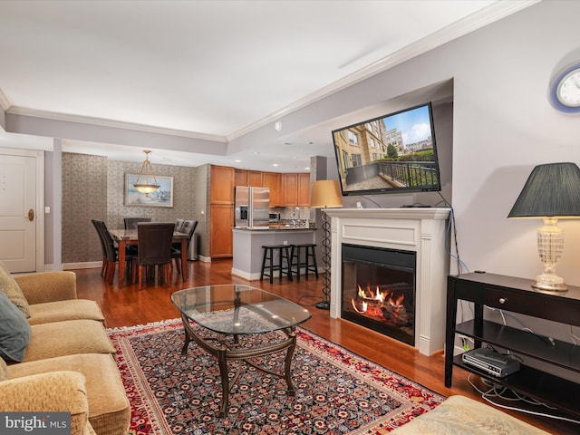 living room with dark wood-type flooring and ornamental molding