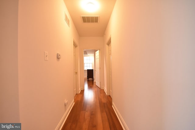 hall with dark hardwood / wood-style flooring