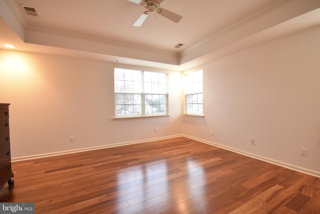 spare room with dark hardwood / wood-style floors, ceiling fan, and crown molding