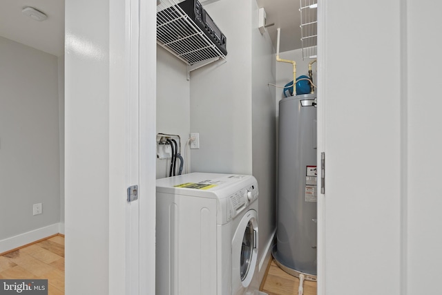 laundry room featuring water heater, hardwood / wood-style flooring, and washer / dryer