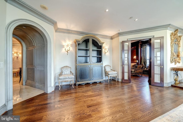 interior space with crown molding, french doors, and wood-type flooring