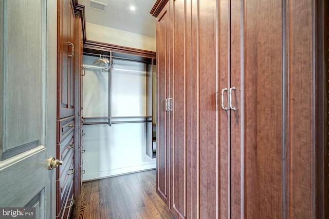 walk in closet featuring dark hardwood / wood-style floors