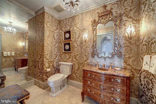 bathroom with toilet, vanity, an inviting chandelier, and ornamental molding