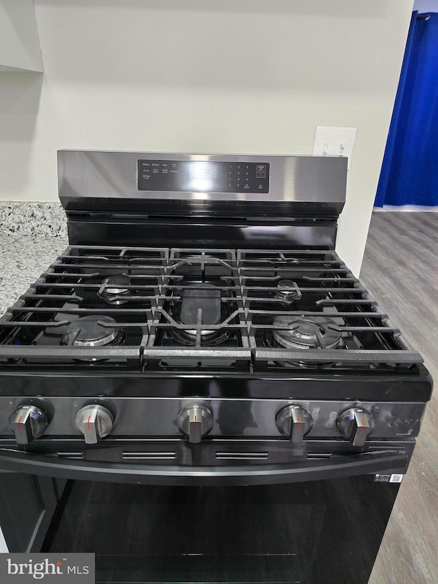 interior details with wood-type flooring and stainless steel gas range