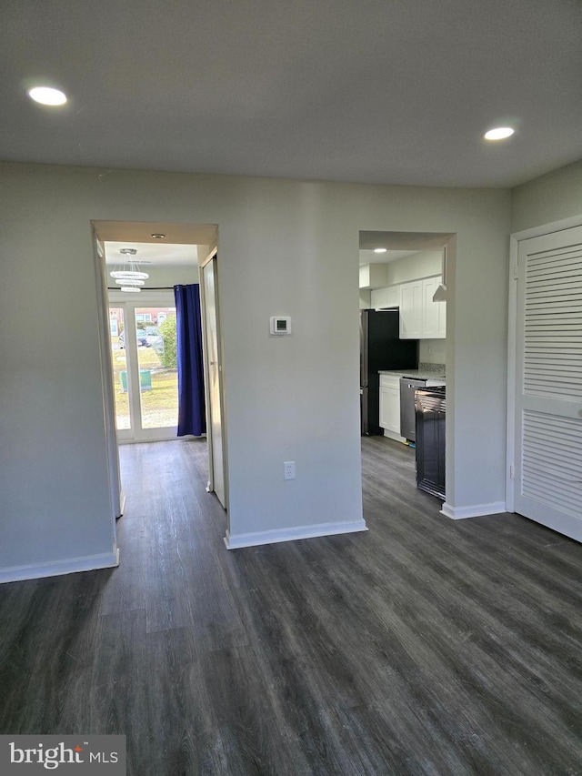 unfurnished living room featuring dark hardwood / wood-style floors