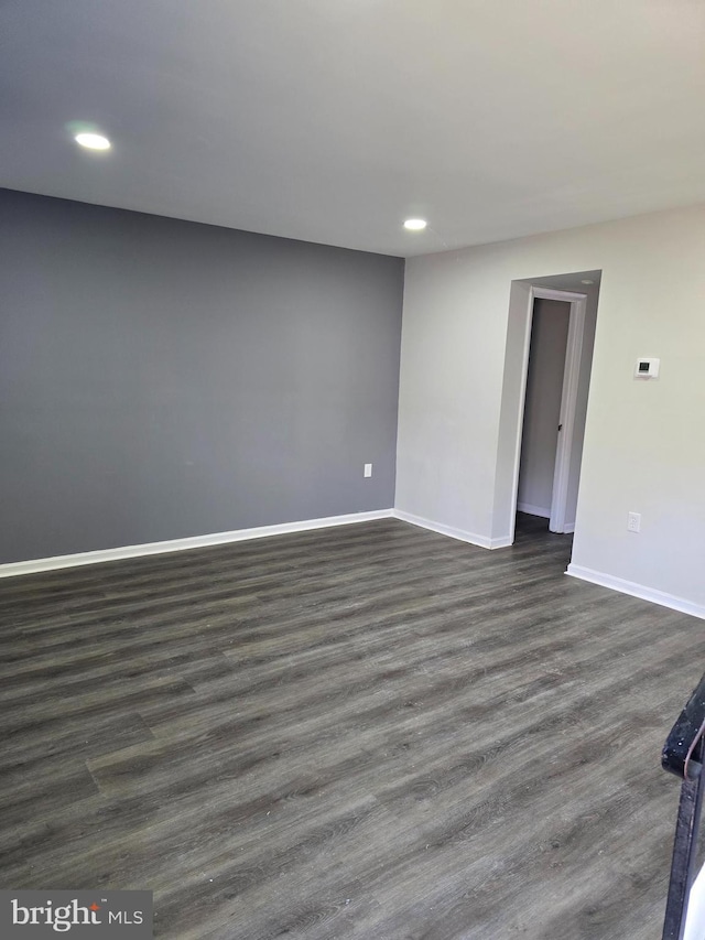 unfurnished room with dark hardwood / wood-style flooring