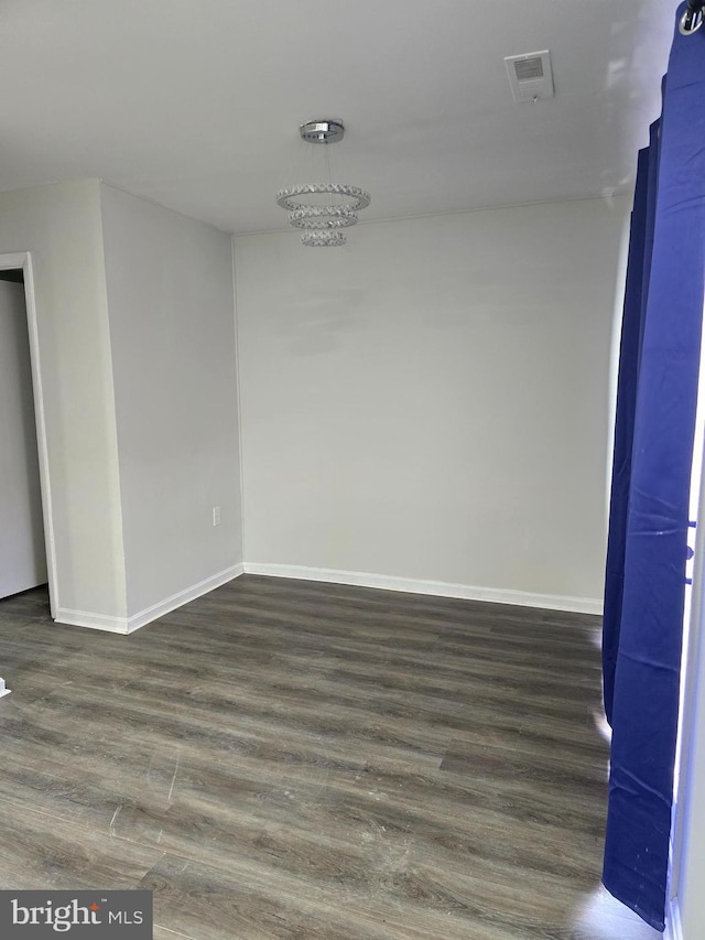 empty room featuring dark hardwood / wood-style flooring