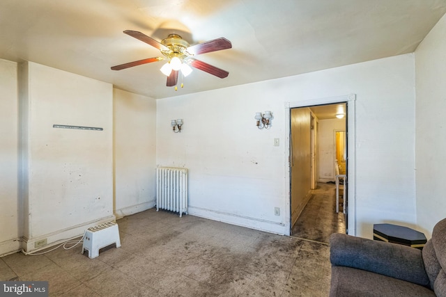 spare room featuring ceiling fan and radiator