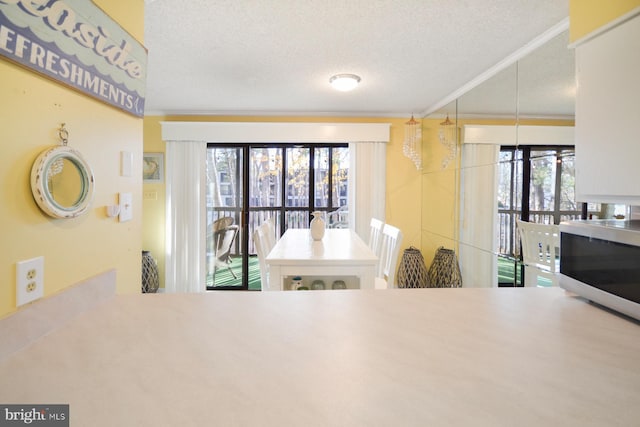 kitchen with ornamental molding and a textured ceiling