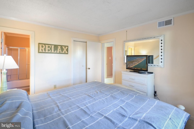 bedroom featuring crown molding, connected bathroom, and a closet