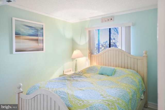 bedroom featuring ornamental molding and a textured ceiling