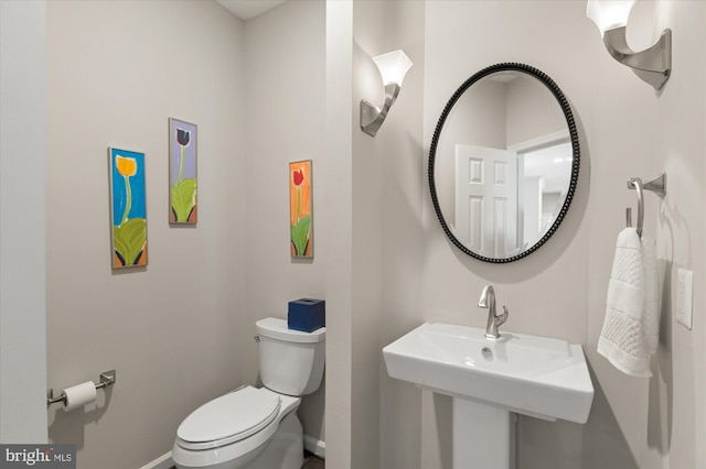 bathroom featuring sink and toilet